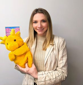 A photo of Lauren with a handpuppet she uses in her therapy sessions