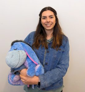 Cheri Strecker with a plush Eeyore toy