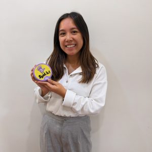 Alyssa Cajes holding her favourite therapy toy, a game of Spotit!